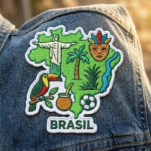 May include: An embroidered patch shaped like the map of Brazil in bright green with a white border. It features a toucan, the Christ the Redeemer statue, a palm tree, a colorful mask, a gourd, a soccer ball, and a blue river. The text BRASIL is below.