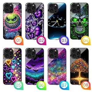 May include: A collection of eight rectangular smartphone cases featuring diverse graphic designs including a green monster, purple butterflies, a clock face, a green skull, colorful hearts, bats, a nebula pattern, and a glowing tree.