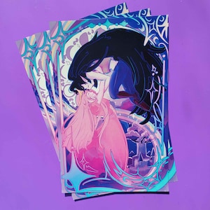 May include: Three art prints featuring a romantic illustration of two figures embracing. One figure has long black hair and the other has long pink hair. The artwork is framed with a blue and teal border and a rainbow.