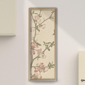 May include: A framed botanical print featuring a branch with pink and white blossoms and green leaves. The artwork is set against a beige background and framed in a gold-colored frame. The print is rectangular and vertically oriented.