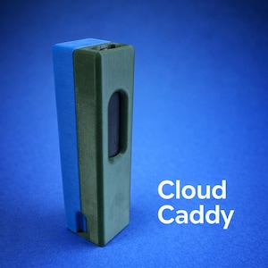 May include: A rectangular, two-tone Cloud Caddy in blue and green, with a curved cutout and the text "Cloud Caddy" in white. The caddy is set against a blue background.
