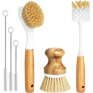May include: A set of kitchen cleaning brushes and bottle brushes. The set includes a dish brush, a bottle brush, a small round brush, and three thin cleaning brushes. The brushes have light brown wooden handles and white and tan bristles.