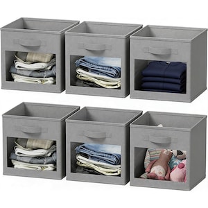 May include: A set of three ceramic mugs with a speckled, matte finish. The mugs are in shades of cream, light gray, and dark gray. Each mug has a simple, minimalist design, perfect for coffee or tea.