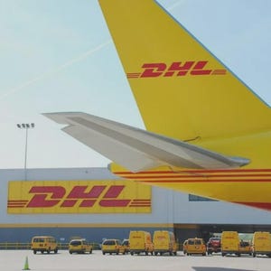 May include: A yellow DHL airplane tail with the DHL logo and a row of yellow DHL vans parked in front of a building with the DHL logo. The sky is blue.