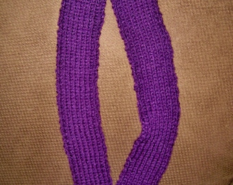 May include: A purple knitted infinity scarf. The scarf is made of a soft, textured yarn and is a simple, classic design.