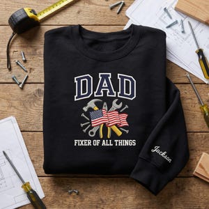 Jackson Sleeve Name Embroidered Dad Crewneck, Fixer Of All Things Sweatshirt, American Flag Handyman Shirt, Patriotic Father Day Gift