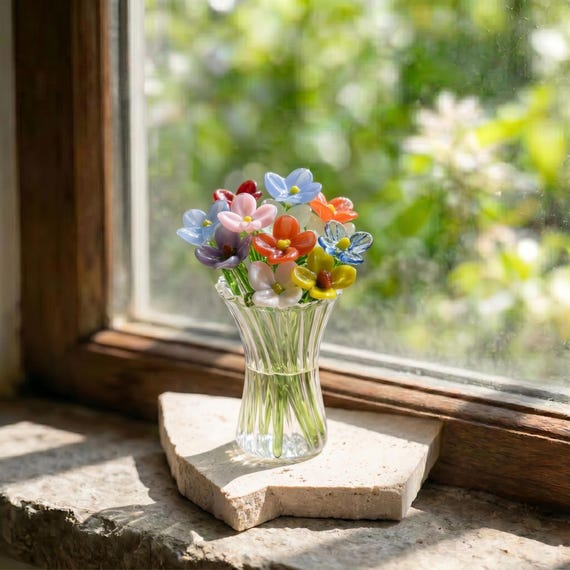 A hand-blown borosilicate glass flower bouquet — permanently in bloom, made by a real flameworker, and fits in your pocket.