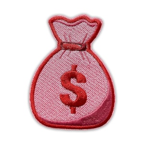 May include: Embroidered patch featuring a pink money bag with a red outline and a red dollar sign. The patch has a textured appearance and is designed to be ironed or sewn onto fabric. The design is a symbol of wealth and financial success.