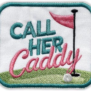 May include: Embroidered patch with the text "CALL HER CADDY" in teal and pink. The patch features a golf flag, a golf ball, and green grass. The patch has a teal border and is on a white background.