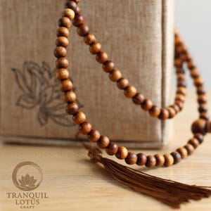 Close-up of 108 Green Cypress mala beads showing natural wood grain and tassel — aromatic Buddhist prayer beads for meditation practice, 8mm solid wood