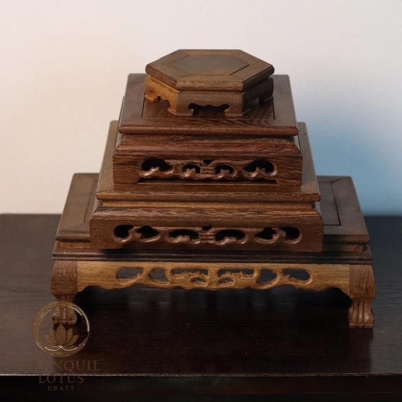 Hand stacking carved dark wood display stands showing all sizes: small Hexagon 4.7 inch, Square 6.3 inch, Square High 7.9 inch, and large Rectangle 11.8 inch base. Solid Sindora wood altar risers.