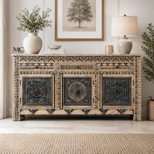 May include: A rectangular wooden sideboard featuring three drawers and three cabinets with intricate black carved patterns on a natural wood finish. The cabinet doors display circular and floral motifs with metal ring pulls, accented by a decorative border.