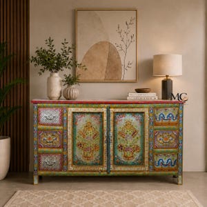 May include: A rectangular wooden sideboard featuring six drawers and two central cabinet doors, all hand-painted with intricate floral patterns in vibrant colors. The piece has a red top surface and metal hardware pulls on each drawer and door.