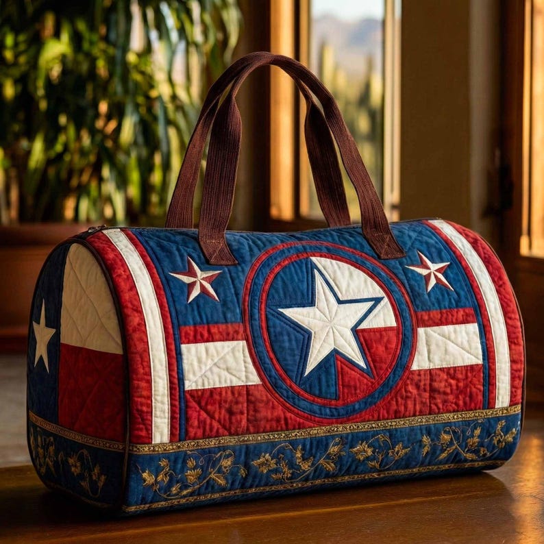May include: A quilted duffel bag featuring a red, white, and blue color scheme with a prominent central star emblem. The design incorporates horizontal stripes and smaller star accents, finished with brown fabric handles and a decorative floral border.