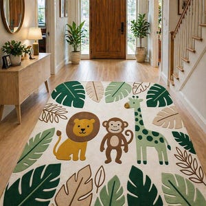 May include: A rectangular area rug with a jungle theme. The rug features a lion, monkey, and giraffe, surrounded by green, tan, and brown leaves on a cream background. The rug is placed in a hallway with wooden floors and a wooden door.