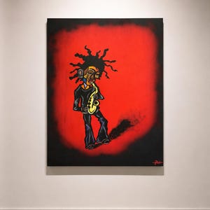 May include: A framed painting depicts a stylized figure playing a yellow saxophone against a red and black background. The figure wears a black suit with flared pants and has distinctive, spiky hair. The artwork is signed in the lower right corner.