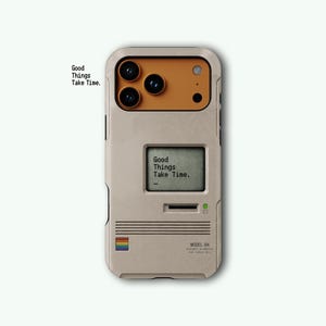 May include: A beige smartphone case featuring a retro computer design with a mustard yellow camera module, a small screen displaying the text Good Things Take Time, a rainbow square icon, and the text Model 84 printed on the lower right corner.