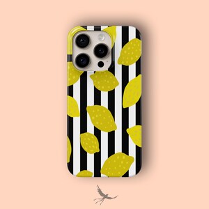 May include: A phone case with a black and white striped background and a pattern of yellow lemons. The case has a yellow border and a camera cutout.