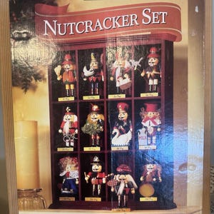May include: A Member's Mark Nutcracker Set box featuring a display case with twelve individual nutcracker figures, each representing a day of Christmas. The packaging displays the text Nutcracker Set and Member's Mark at the top.