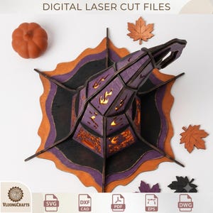 May include: A 3D laser-cut wooden witch hat decoration featuring purple, black, and orange layers with cutouts of flames, stars, and moons. The set includes a small orange pumpkin and several maple leaf cutouts. Text reads DIGITAL LASER CUT FILES.