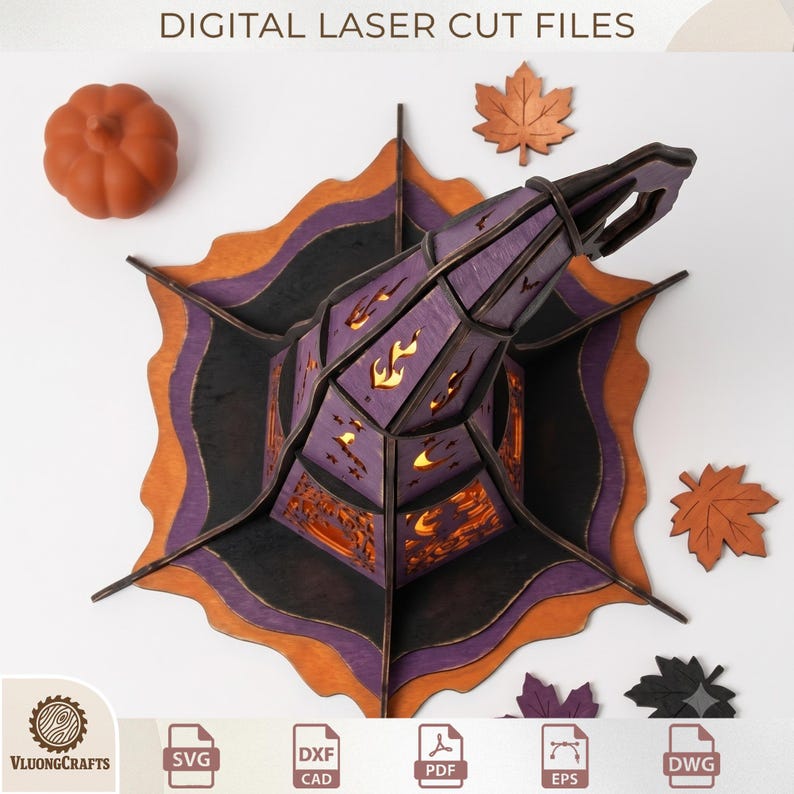 May include: A 3D laser-cut wooden witch hat decoration featuring purple, black, and orange layers with cutouts of flames, stars, and moons. The set includes a small orange pumpkin and several maple leaf cutouts. Text reads DIGITAL LASER CUT FILES.