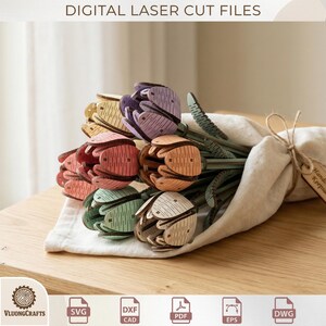 May include: A bouquet of laser-cut wooden tulips in various colors, including pink, purple, orange, green, and yellow. The flowers are tied together with a beige cloth and twine. The text "DIGITAL LASER CUT FILES" is at the top.