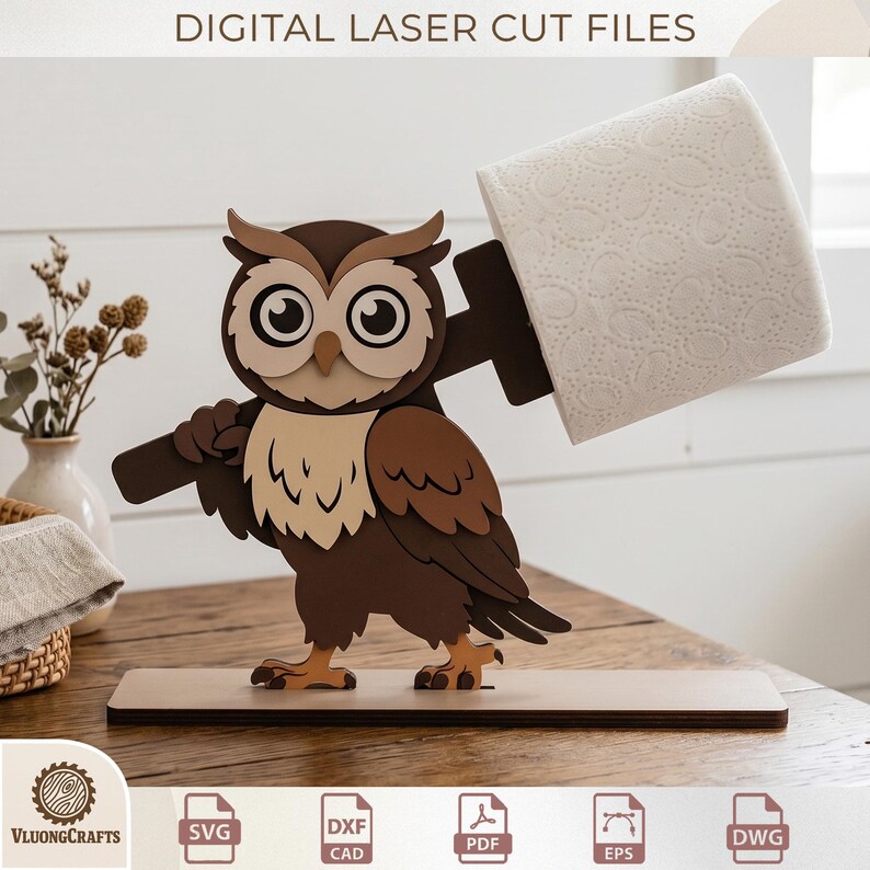 May include: A wooden owl-shaped toilet paper holder. The owl is brown, beige, and white, holding a brown arm that supports a roll of white toilet paper. The base is a light brown rectangle. The text "DIGITAL LASER CUT FILES" is at the top.