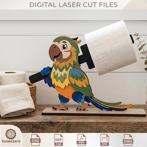 May include: A colorful wooden parrot toilet paper holder. The parrot has a brown beak, green, yellow, and orange feathers, and blue feet. The holder is holding a roll of white toilet paper. The text "DIGITAL LASER CUT FILES" is at the top.