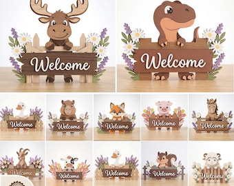 May include: A collection of laser-cut wooden welcome signs featuring various animals, including a moose, dinosaur, fox, and pig. Each sign has a "Welcome" message and decorative floral elements. The signs are designed for digital laser cutting.