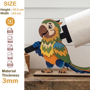 May include: A wooden parrot-shaped toilet paper holder. The colorful parrot has a brown beak, blue and green wings, and an orange chest. The holder is 18.5 cm high and 24 cm wide. Material thickness is 3mm.