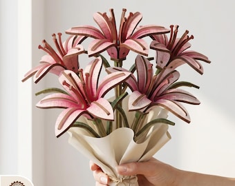 May include: A bouquet of pink and brown laser-cut wooden lilies. The flowers are arranged in a cream-colored paper wrap, tied with twine. The image includes the text "DIGITAL LASER CUT FILES" at the top and various file type icons at the bottom.