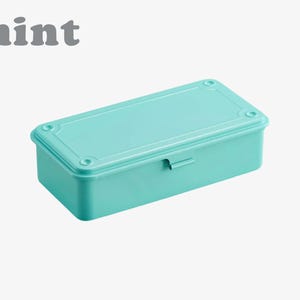 May include: A rectangular mint-colored storage box with a matching lid. The lid has rounded corners and is secured with a small metal clasp. The word "mint" is printed in gray, stylized text above the box.
