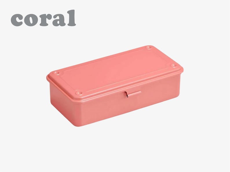 May include: A coral-colored rectangular storage box with a matching lid. The box has rounded corners and a small metal latch. The word "coral" is printed in gray in the upper left corner.