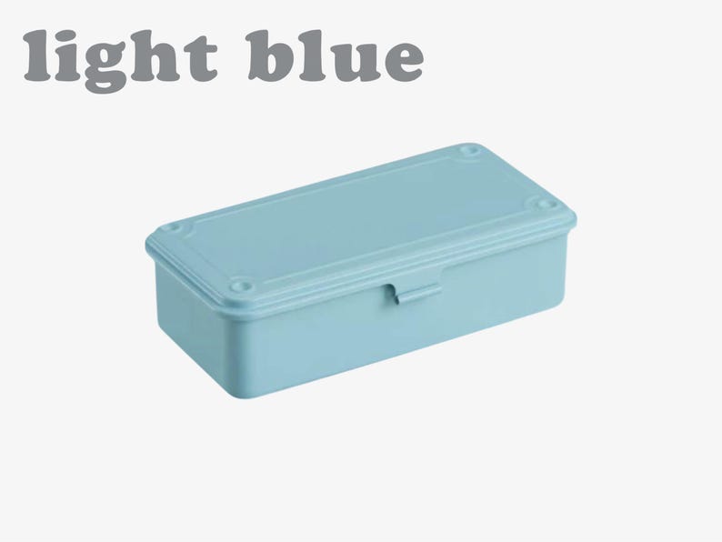 May include: A light blue rectangular box with a matching lid. The lid has a decorative border and is secured with a small latch. The words "light blue" are printed above the box.