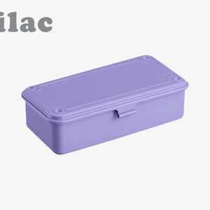 May include: A rectangular lilac-colored box with a matching lid. The box has a latch on the front and decorative details on the corners. The word "lilac" is printed in gray above the box.