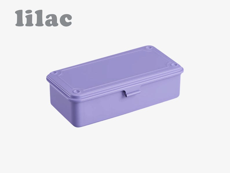 May include: A rectangular lilac-colored box with a matching lid. The box has a latch on the front and decorative details on the corners. The word "lilac" is printed in gray above the box.