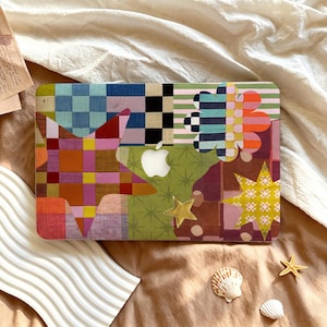 May include: A laptop skin featuring a vibrant collage of patterns including a large multicoloured checkered star, a green section with star icons, a floral shape with striped petals, and a yellow star, centred around a white Apple logo cutout.
