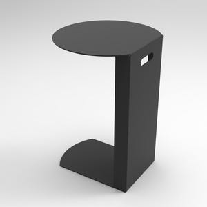 May include: A modern, black side table with a circular tabletop and a rectangular base. The table has a handle cut-out on the side for easy portability. The table's dimensions are approximately 20 inches in height and 12 inches in width.