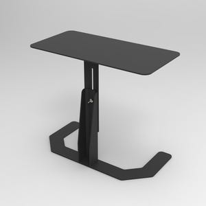 May include: A black, adjustable side table with a rectangular top. The table has a single support column and a U-shaped base. The table is made of metal and has a matte finish. The table is designed for use in a living room or bedroom.