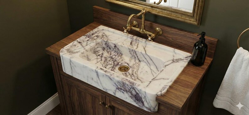 May include: A rectangular marble sink with purple veining sits atop a dark wood vanity. A gold faucet and a black soap dispenser are visible. The sink is a focal point in a bathroom setting.