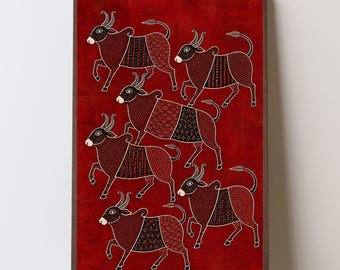 May include: A rectangular framed wall art piece featuring a deep red background with six stylized bulls in black and white. Each bull is decorated with intricate geometric patterns, including dots, lines, and scales, arranged in a dynamic composition.
