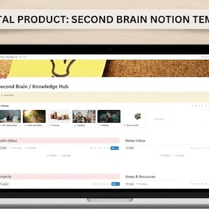 May include: A laptop displays a digital Notion template titled "Second Brain / Knowledge Hub." The screen shows various sections for tasks, notes, projects, and resources. The laptop sits on a light wood surface, with a notepad, pen, and plant nearby.