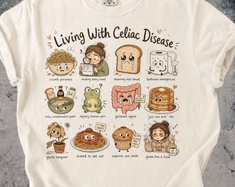 May include: An off-white t-shirt featuring a graphic titled Living With Celiac Disease. The design includes twelve cartoon illustrations depicting various aspects of the condition, each with a descriptive caption such as crumb paranoia, bathroom emergencies, and gluten free & tired.