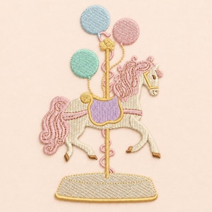 May include: An embroidered patch featuring a carousel horse in cream with a pink mane and tail, a purple saddle, and a gold pole. The horse is surrounded by three balloons in light blue, mint green, and pink, all set on a gold base.