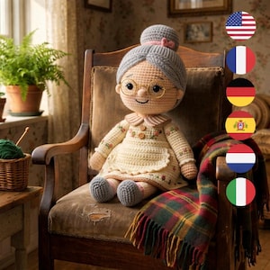 May include: A handmade crochet doll of a smiling elderly woman with glasses, gray hair, and a bun. She wears a cream-colored dress with floral accents and sits on a vintage wooden chair. A plaid blanket is draped over the chair.