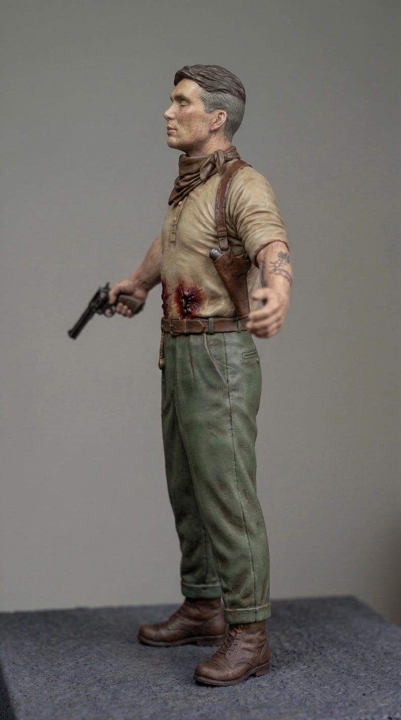 May include: A detailed figurine of a person with short dark hair, wearing a tan long-sleeve shirt with a visible chest wound, a brown neckerchief, a brown leather shoulder holster, green trousers, and brown boots, holding a black revolver in one hand.