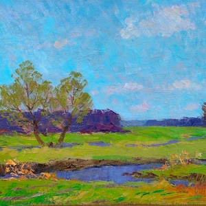 May include: An oil painting of a landscape featuring a bright blue sky with fluffy white clouds. The foreground shows a green field with a small stream. Two trees with green foliage stand in the center, with purple trees in the background.