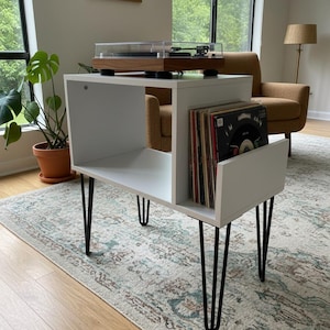 Small-space wooden vinyl stand pairing a turntable surface with compact LP storage in a minimalist form.