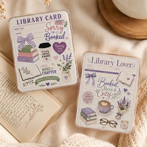 May include: Two rectangular acrylic blocks featuring library card designs. The left block displays 'LIBRARY CARD', 'Sorry I'm Booked', and 'one MORE CHAPTER' with illustrations of books, a coffee cup, a bow, and lavender. The right block says 'Library Lover' and 'Booked, Busy & Cozy' with books, a coffee mug, glasses, and flowers.