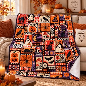 May include: A rectangular throw blanket featuring a patchwork design of Halloween-themed illustrations including black cats, ghosts, pumpkins, mushrooms, bats, spiders, webs, and crows in a vibrant color palette of orange, purple, black, and white.